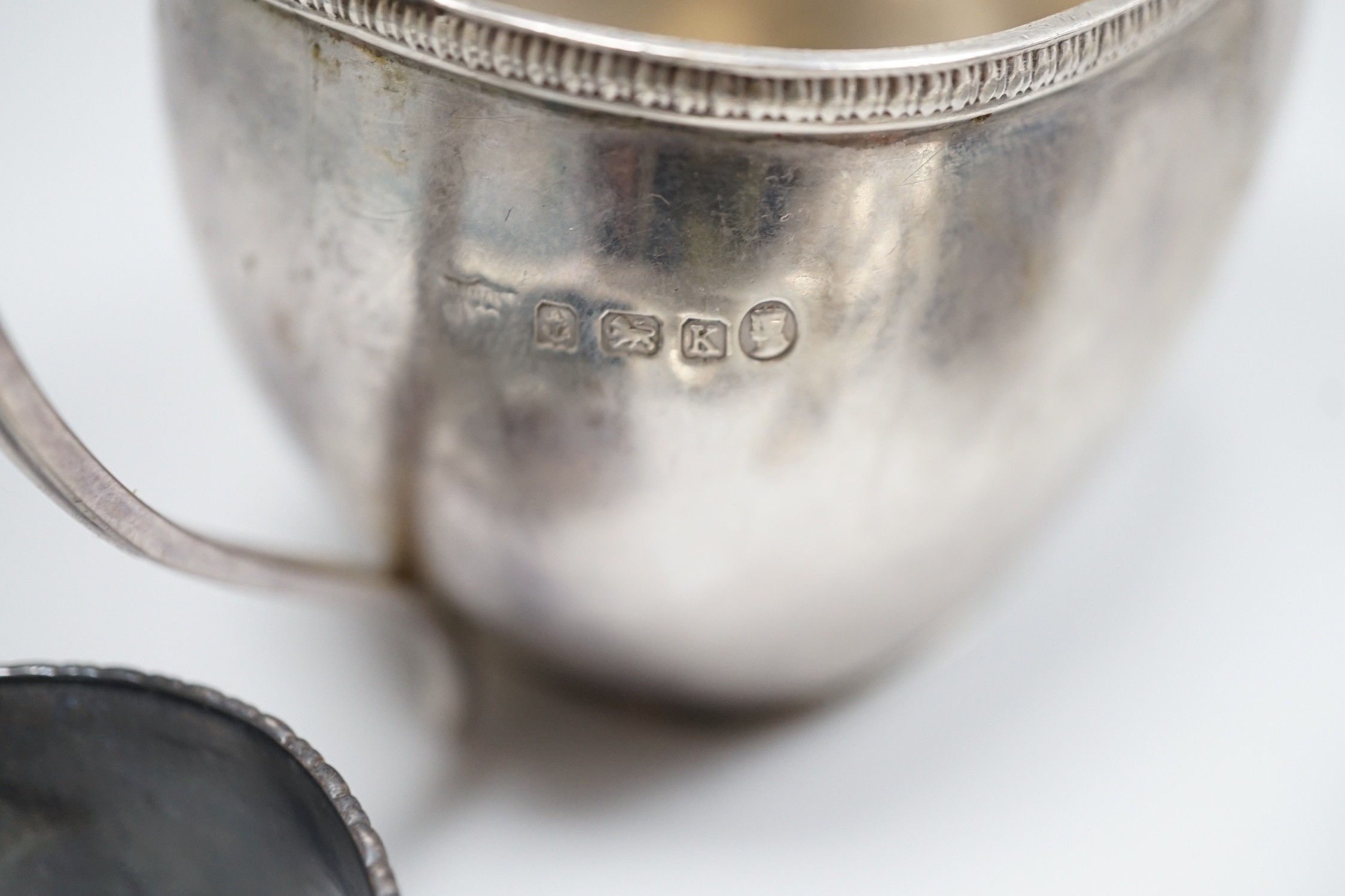 Sundry small silver including a 1930's cream jug, a Victorian mustard pot (no liner), two napkin rings and a small quantity of assorted silver and sterling flatware, 20.8oz.